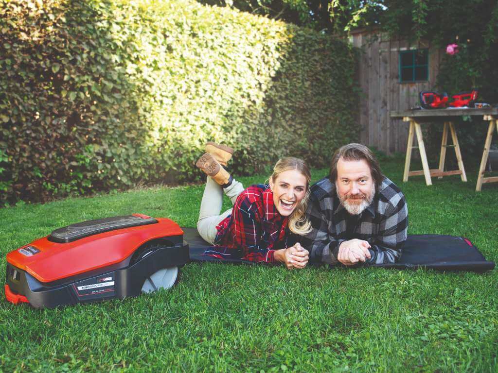 A man an a woman are laughing behind a robotic mover