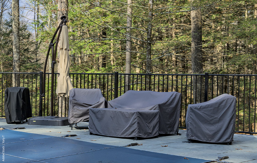 Garden furniture covered for the winter on a balcony