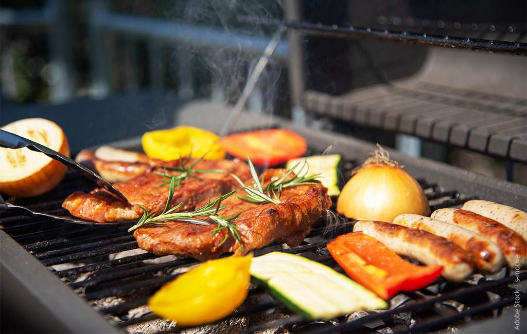 Various vegetables are placed on a grill and being roasted