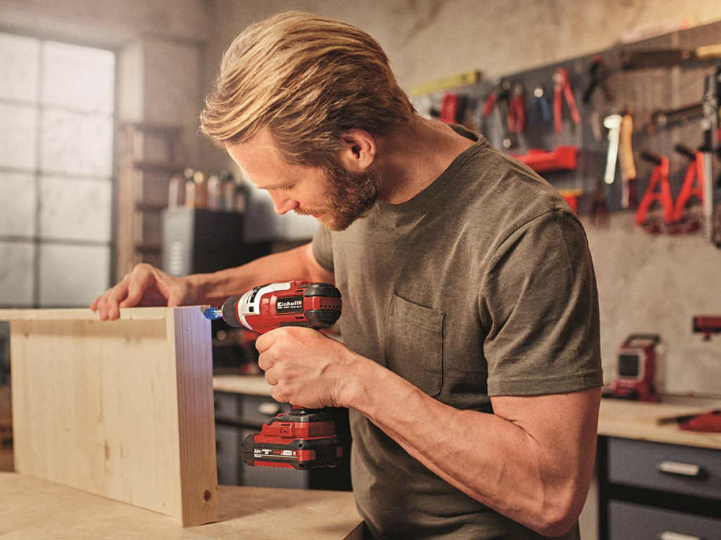 A man building something in a workshop. 