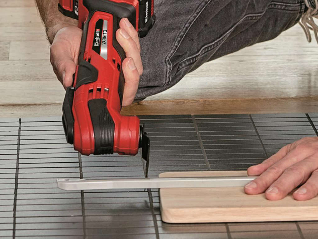 A man using the cordless multifunctional tool.