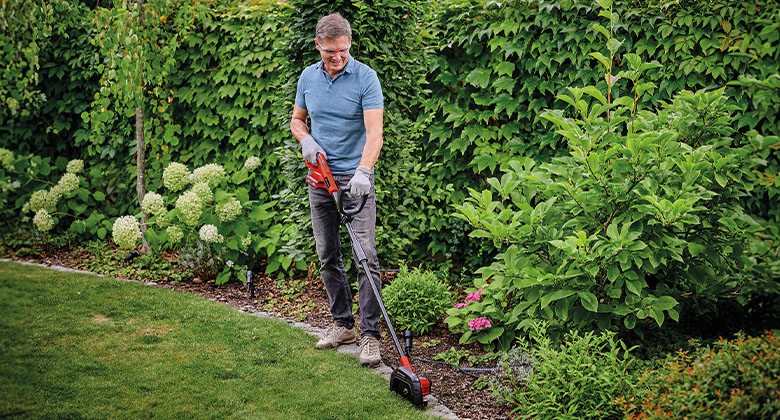 man working with Einhell Cordless Lawn Edge Trimmer