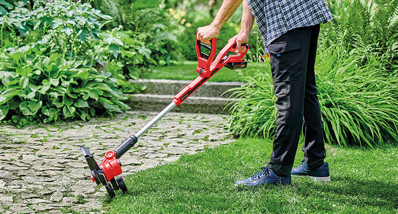 someone using Einhell cordless trimmer