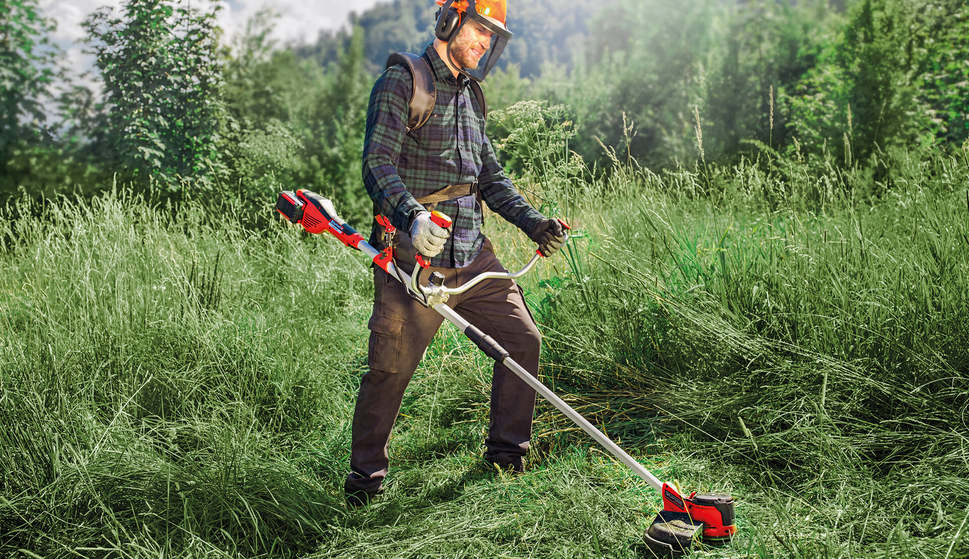 man working with a cordless scythe