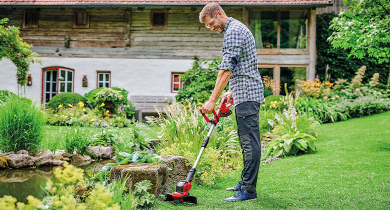 man using Einhell cordless trimmer